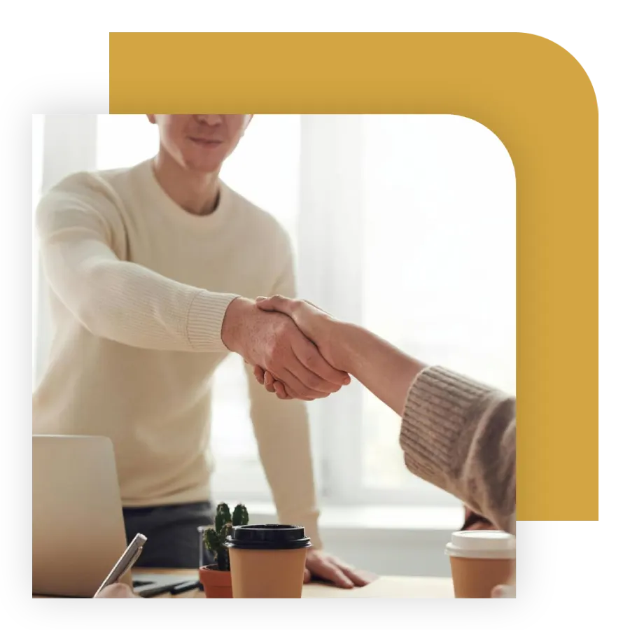 Escrow officer shaking hands with a client after a successful closing